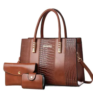 Brown faux leather 3-piece bag set with crocodile embossing and golden metal hardware