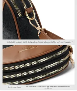 Detail of lychee pattern leather, gold hardware, and three-layer smooth zippers on bag