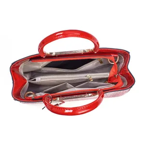 Interior layout of red patent leather Boston bag with compartments and grey lining