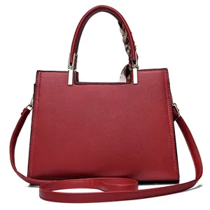 Elegant deep red top handle wedding bag with lychee texture and decorative silk scarf