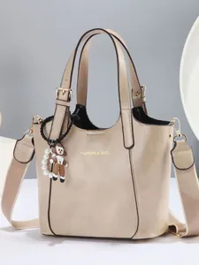 Vintage beige tote bag for women with dual handles, wide strap and pearl charm detail