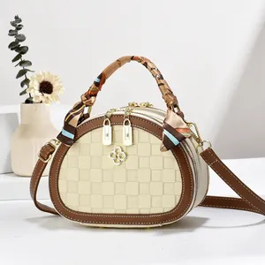 Chic beige woven mini bag with brown leather trim and silk scarf handle detail