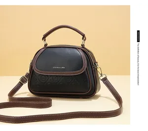 Close-up of the elegant brand embossing and smooth leather texture on the handbag