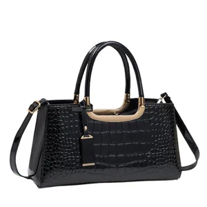 Glossy black embossed crocodile leather Boston handbag with gold metal hardware
