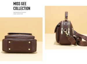 Detail of brown leather handbag with gold zippers and wide fabric shoulder strap