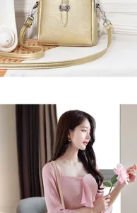 Detail of gold litchi texture shoulder bag with silver buckle worn by a female model