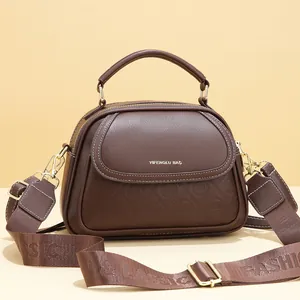 Deep brown multi-layer handbag with textured leather and wide decorative shoulder strap