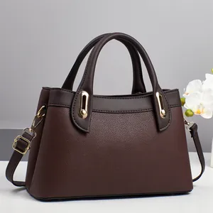 Brown lychee leather tote bag with round handles and adjustable strap for women