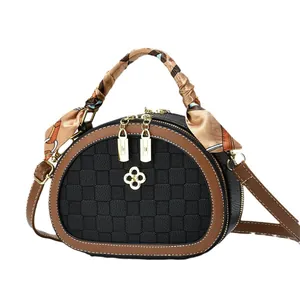 Chic semi-circular crossbody bag with checkerboard texture and floral silk scarf handle