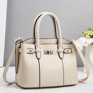Elegant cream litchi grain handbag with silver hardware and detachable shoulder strap