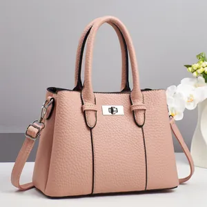 Pale pink lychee grain leather handbag with silver lock and shoulder strap