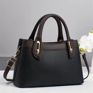 Litchi texture black leather handbag with brown handles and gold hardware details