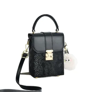 Mini crossbody phone bag for women in black faux leather with snakeskin texture and charm
