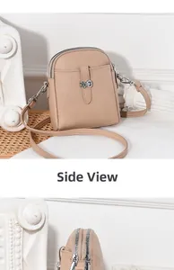 Side view detail of a beige pebbled leather small crossbody bag with silver hardware