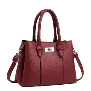 Elegant deep red lychee pattern tote bag with silver metal lock and adjustable shoulder strap