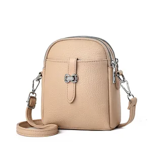 Mini lychee textured leather crossbody phone bag with dual zippers and adjustable strap