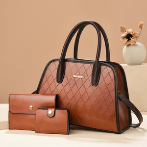 Brown quilted tote bag set with three pieces on a warm background with dried flowers