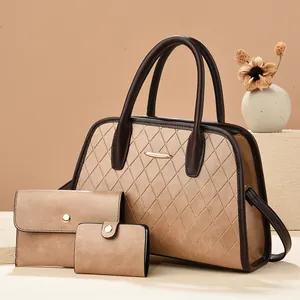 Detailed macro of the brown quilted leather tote with elegant gold metal trim and stitching