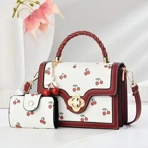 Fashionable cherry print handbag set with matching wallet and floral twist lock closure