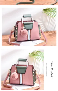 Detail of pink PU leather handbag with striped webbing, green handles and plush charm