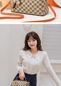 Close-up of Boston bag with checkerboard pattern and floral charm detail shown on model