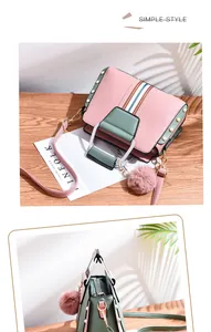 Detail of color-block PU leather handbag with rivets, stripe accents and a fur ball charm