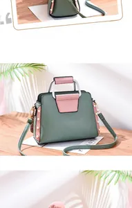 Detail of color-block handbag in dark green and pink with elegant pearl side embellishments