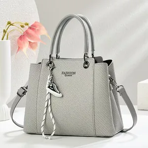 Gray textured handbag for women with dual handles, adjustable strap and sneaker charm