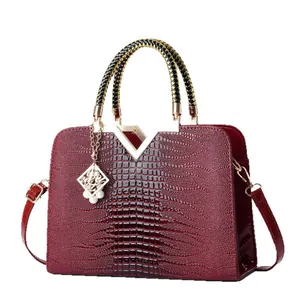 Burgundy crocodile texture handbag with woven handles and V-shaped metal hardware