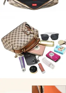 Detailed view of the checkered handbag's inner pocket and large storage capacity