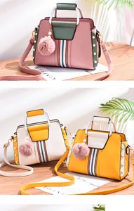 Detailed view of colorful contrast handbags with pearl trim and faux fur pompom accents