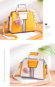 Detail of color-block leather handbags with pearl studs and pink fur ball charms
