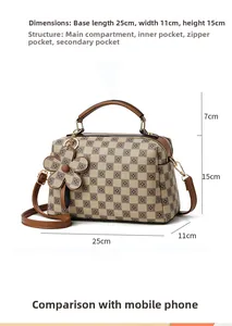 Detailed view of checkered brown handbag with dimensions 25x11x15cm and flower charm