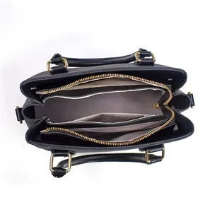 Top view of black pebble leather tote featuring multiple interior compartments and gold zippers