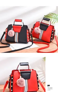 Detail of color-blocked faux leather bags with pearl rivets and faux fur pompom charms