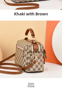 Side view detail of a khaki and brown checkerboard bag with gold zippers and leather handle