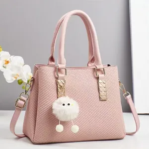 Pink faux leather shoulder bag with diagonal texture and cute white plush ball pendant