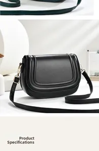 Detail of black leather saddle bag with curved quilted lines and gold-tone metal buckle