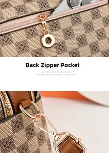 Detail of checkered pillow bag showing back zipper pocket and golden hardware hooks