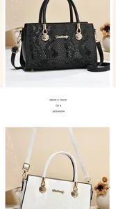 Details von schwarz-weißen Handtaschen mit Schlangenprägung und Goldbeschlägen
