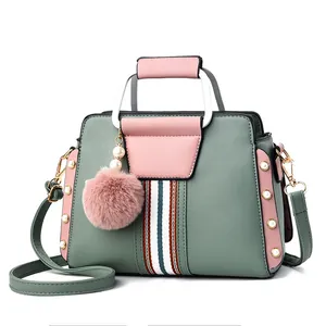 Green and pink contrast color PU handbag with metal handle and pompom charm decoration