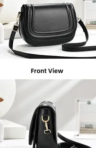 Detail showing high-quality black faux leather texture and gold hardware on a saddle bag