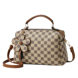 Women's checkerboard pattern pillow bag with top handles and adjustable strap