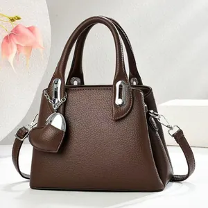 Dark brown lychee pattern bucket bag with leather heart charm and silver metal hardware
