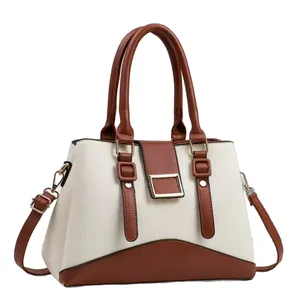 Chic cream and brown crossbody handbag with top handles and gold-tone hardware