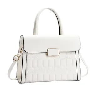 Structured white handbag with embossed texture and gold metallic hardware on a white background