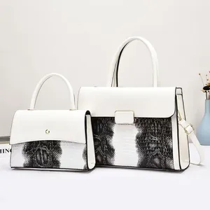 Two-piece white tote bag set with snakeskin print accents and gold hardware