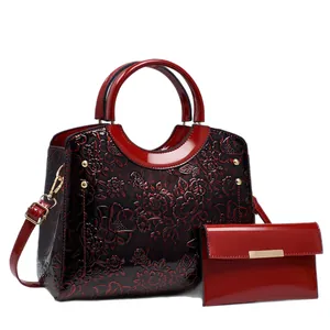 Sac à main rouge foncé avec motifs floraux en relief et portefeuille assorti