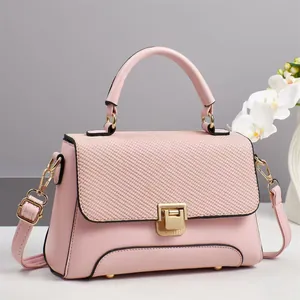Elegant light pink leather handbag with woven flap and gold metal hardware for women