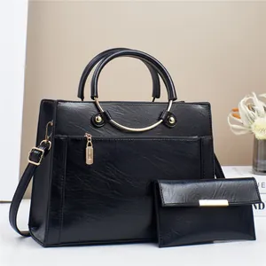 Black leather tote bag and wallet set with stylish golden ring handles and hardware